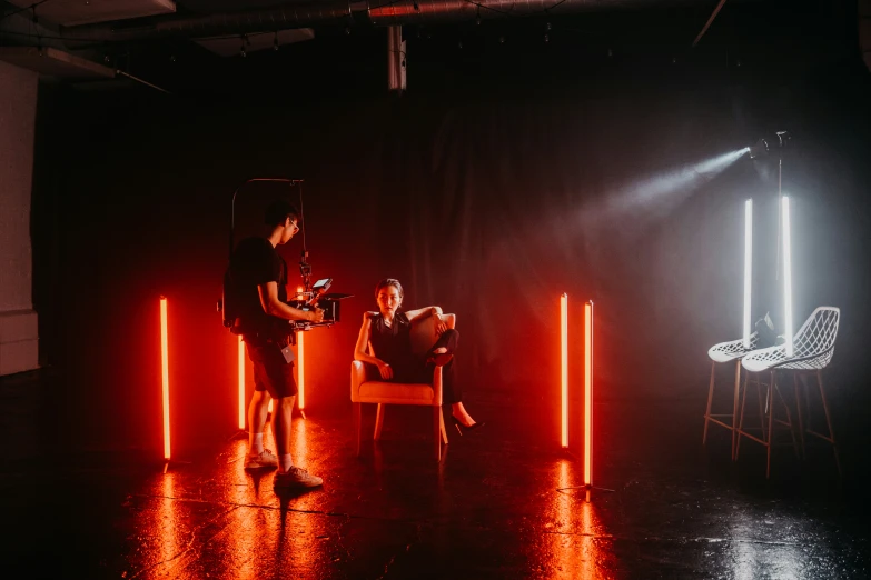 a group of people are sitting in a dimly lit room