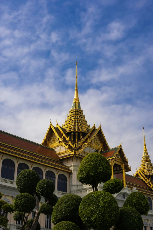 view of a golden spire with topiary in the foreground