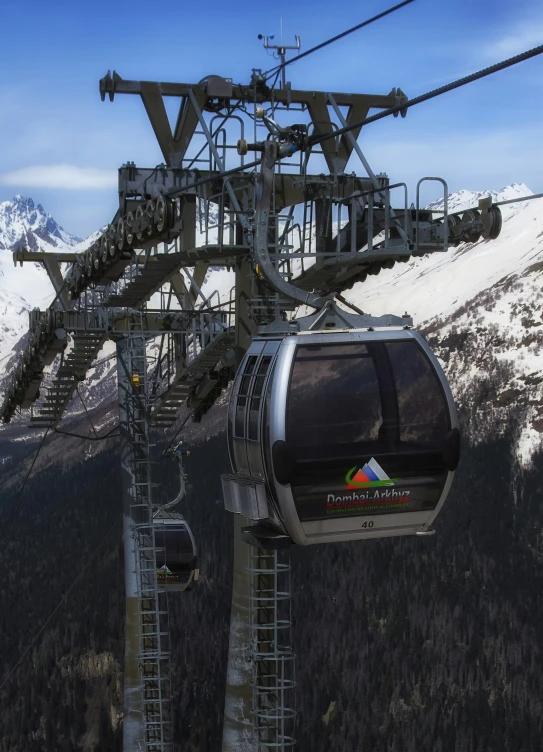 two gondolas with ski lift in foreground on a mountain