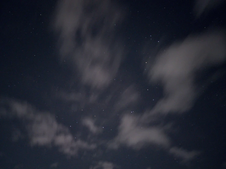 a very dark sky with some lights and stars