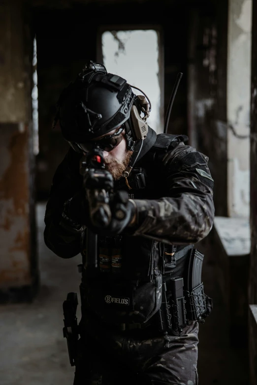 an armed man standing in a building holding a machine gun