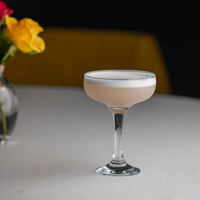 a martini with a flower vase sitting on the table