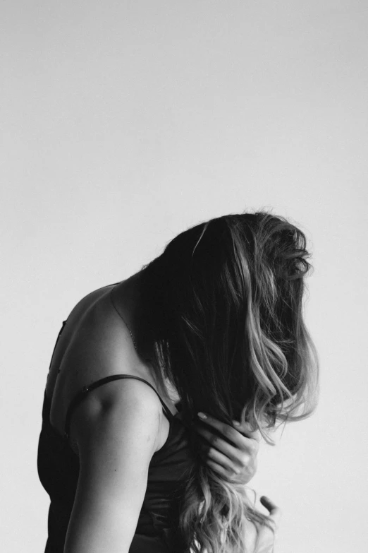 a person fixing their hair while they both stand side by side