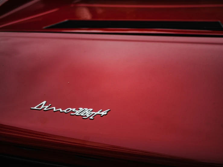 the emblem on the side of a red car