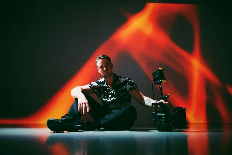 man with his camera and light painting behind him