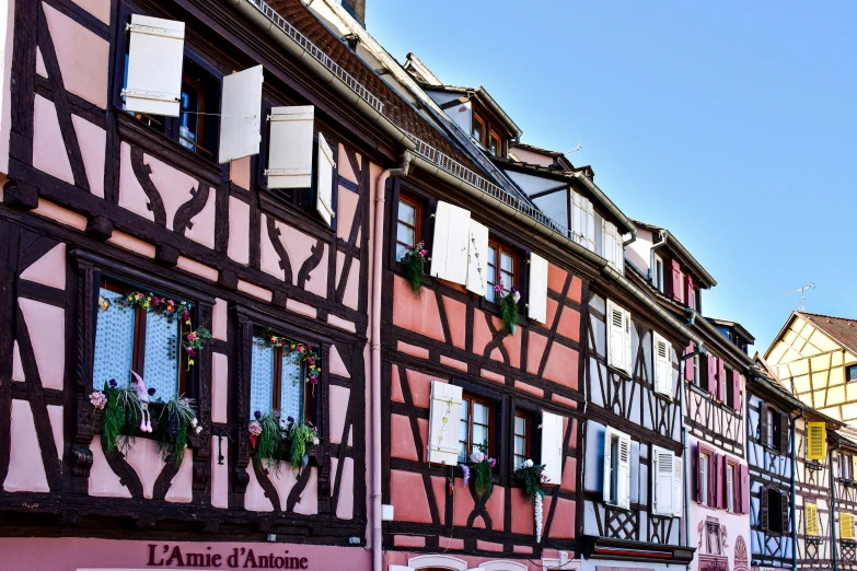 there are several houses in different colors with decorative window boxes on each