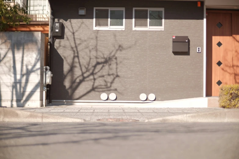 three white balls sit in front of the garage