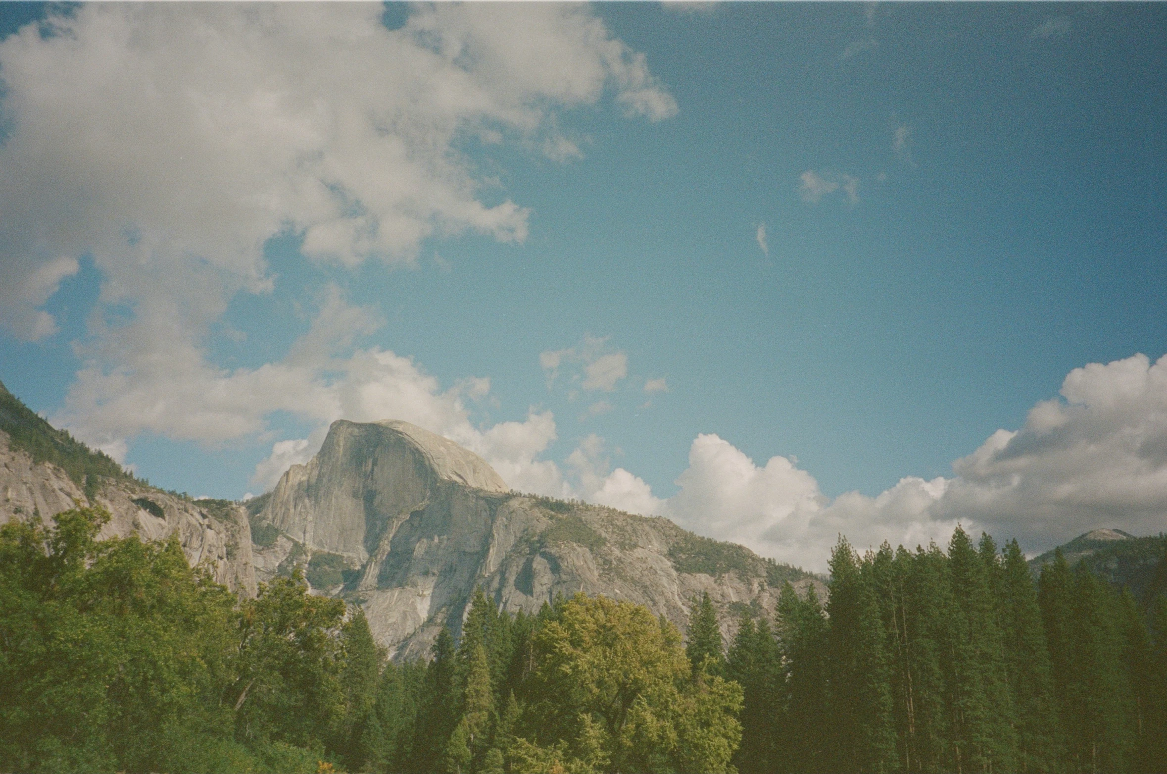 the view is from behind the mountains in a field