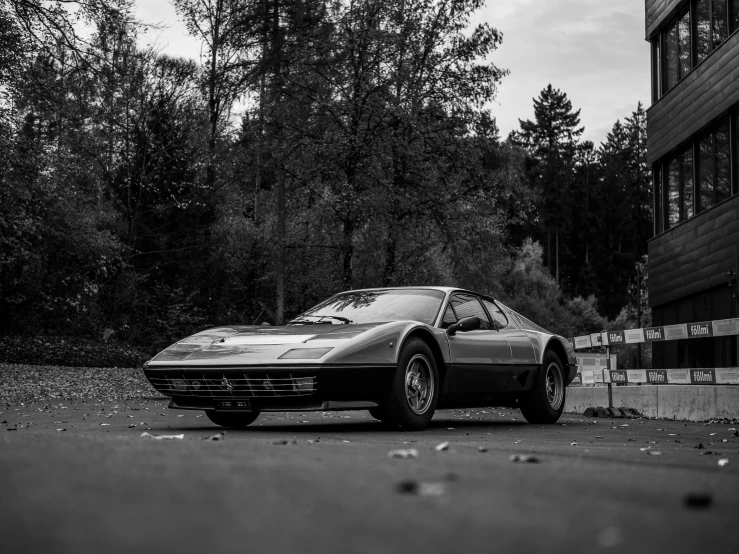 a black and white image of a car parked on the side of the road