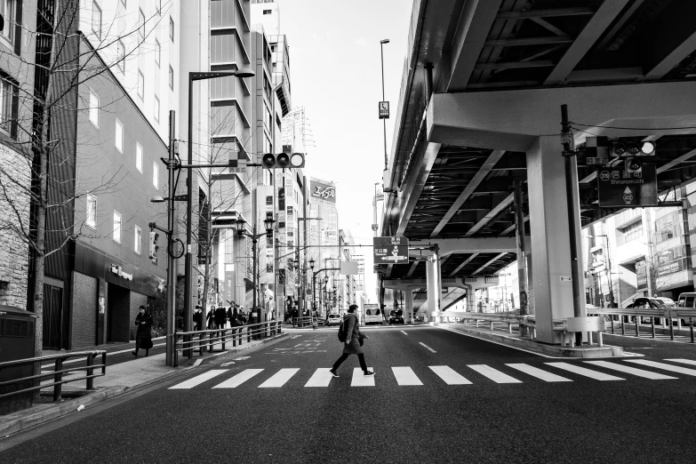 a person walking down a street holding an umbrella