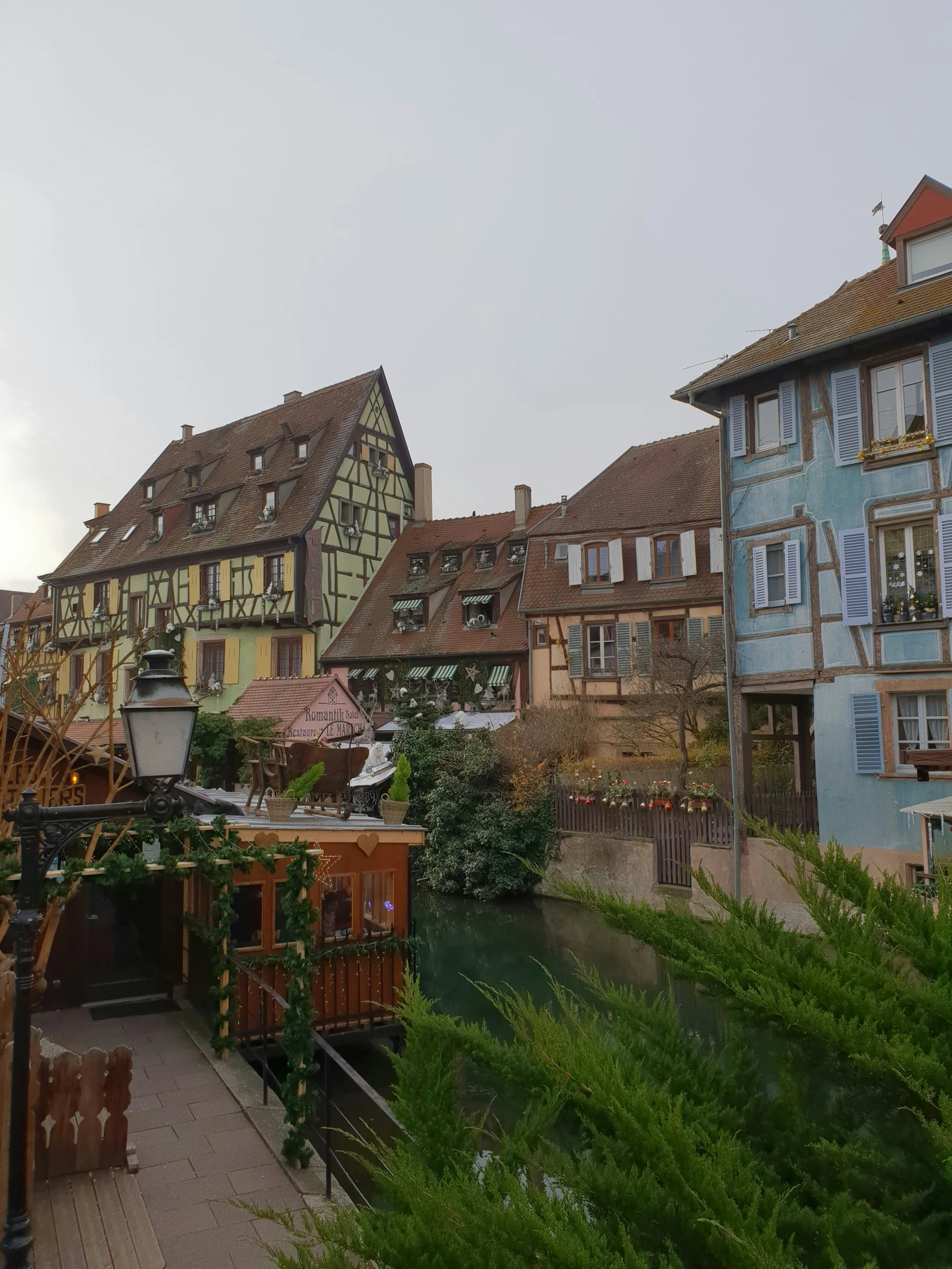 a bridge leads into a river surrounded by buildings