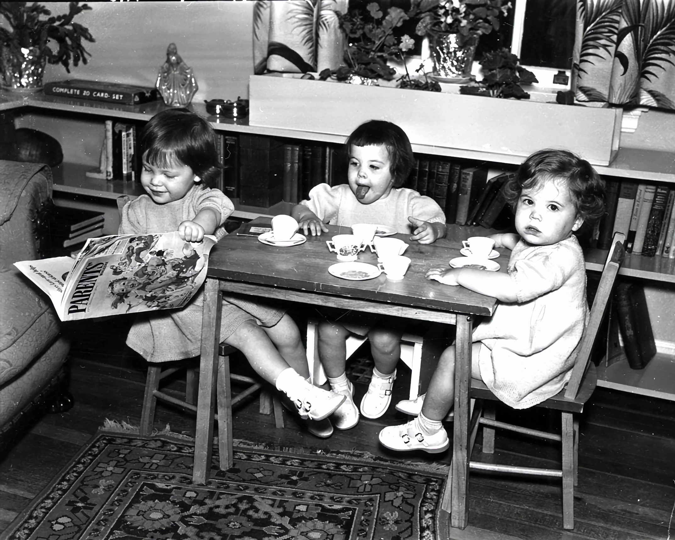 the small children are enjoying their tea time in the house