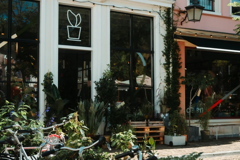 an outside view of a flower shop with bikes parked in front