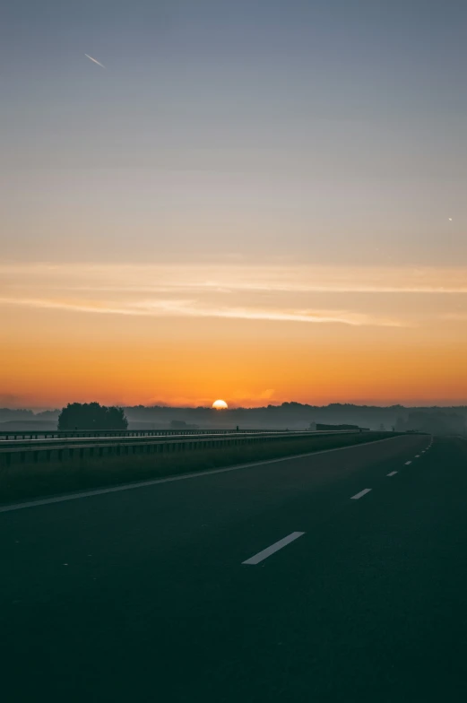 a rural highway during a colorful sunset