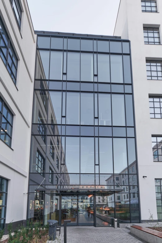 a glass building with many windows and steps on the ground