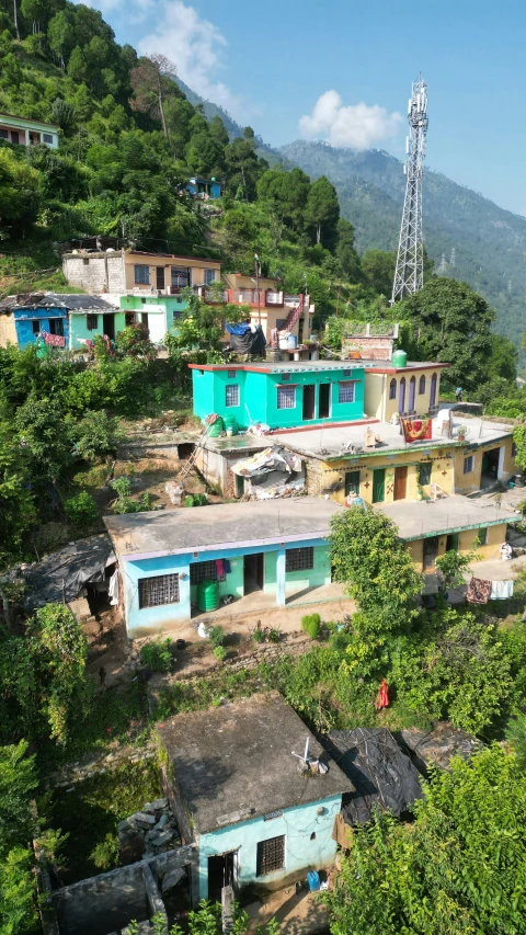 several old buildings on top of a steep hill