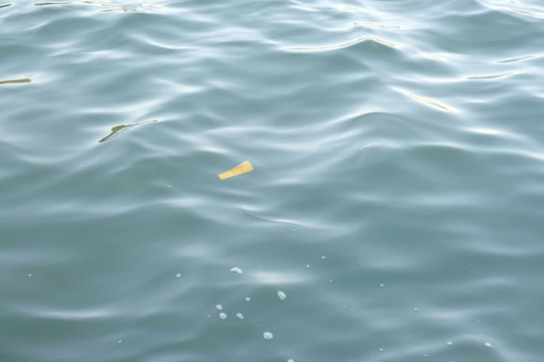 a yellow object floating in the middle of the ocean