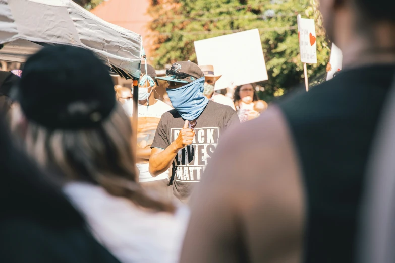 a group of people are standing under a tent