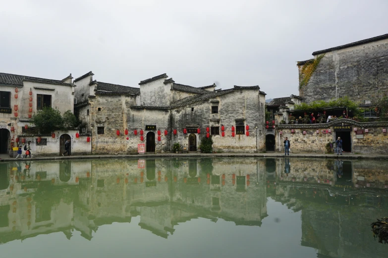 a village and some buildings reflected in water