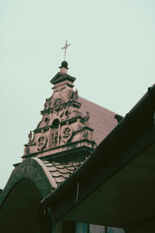 the roof of a church with an antique clock