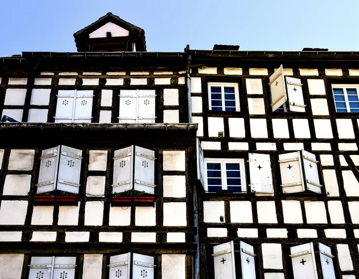 many windows and half of an old building