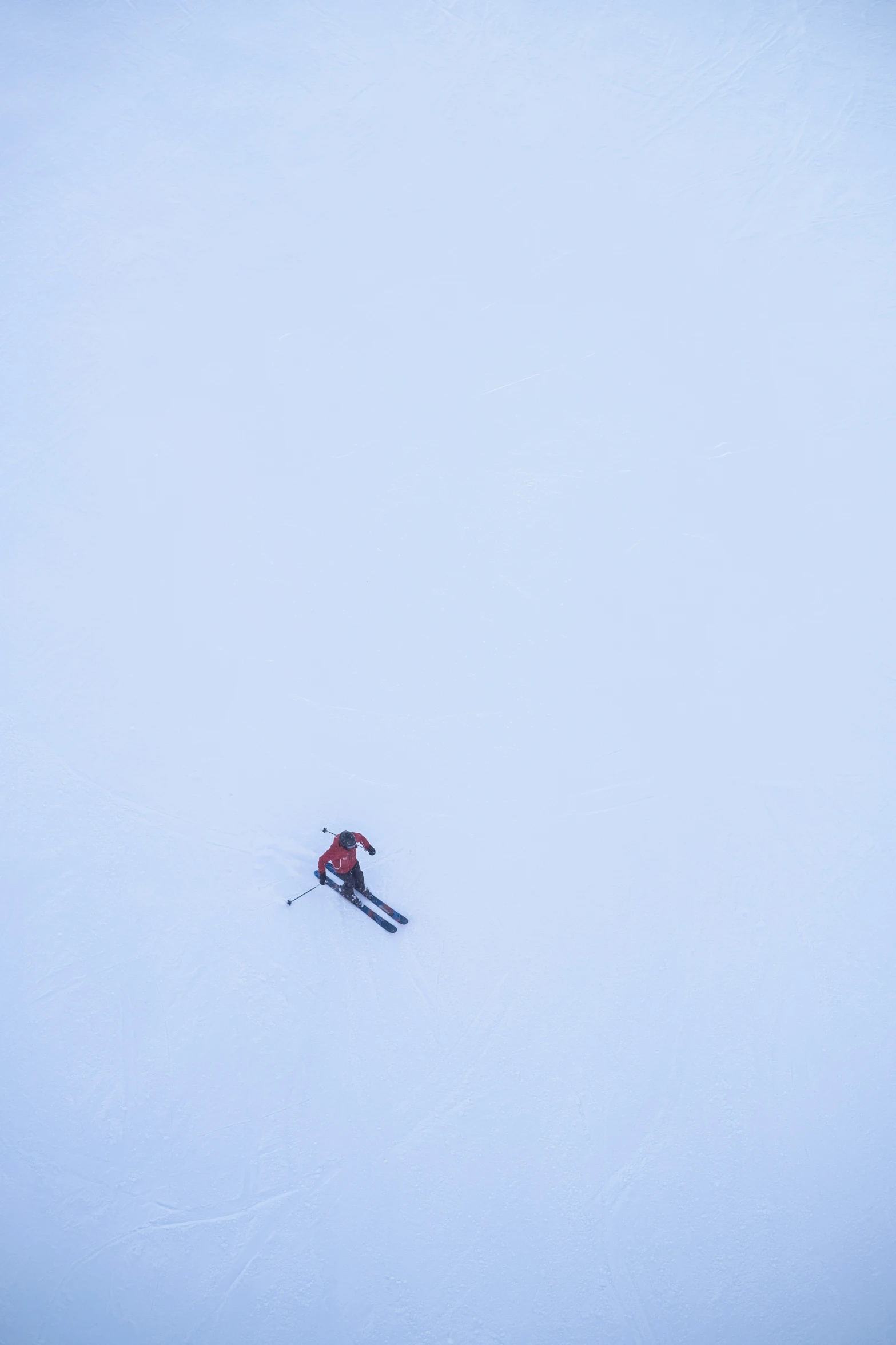 a person in snow gear is skiing down a hill