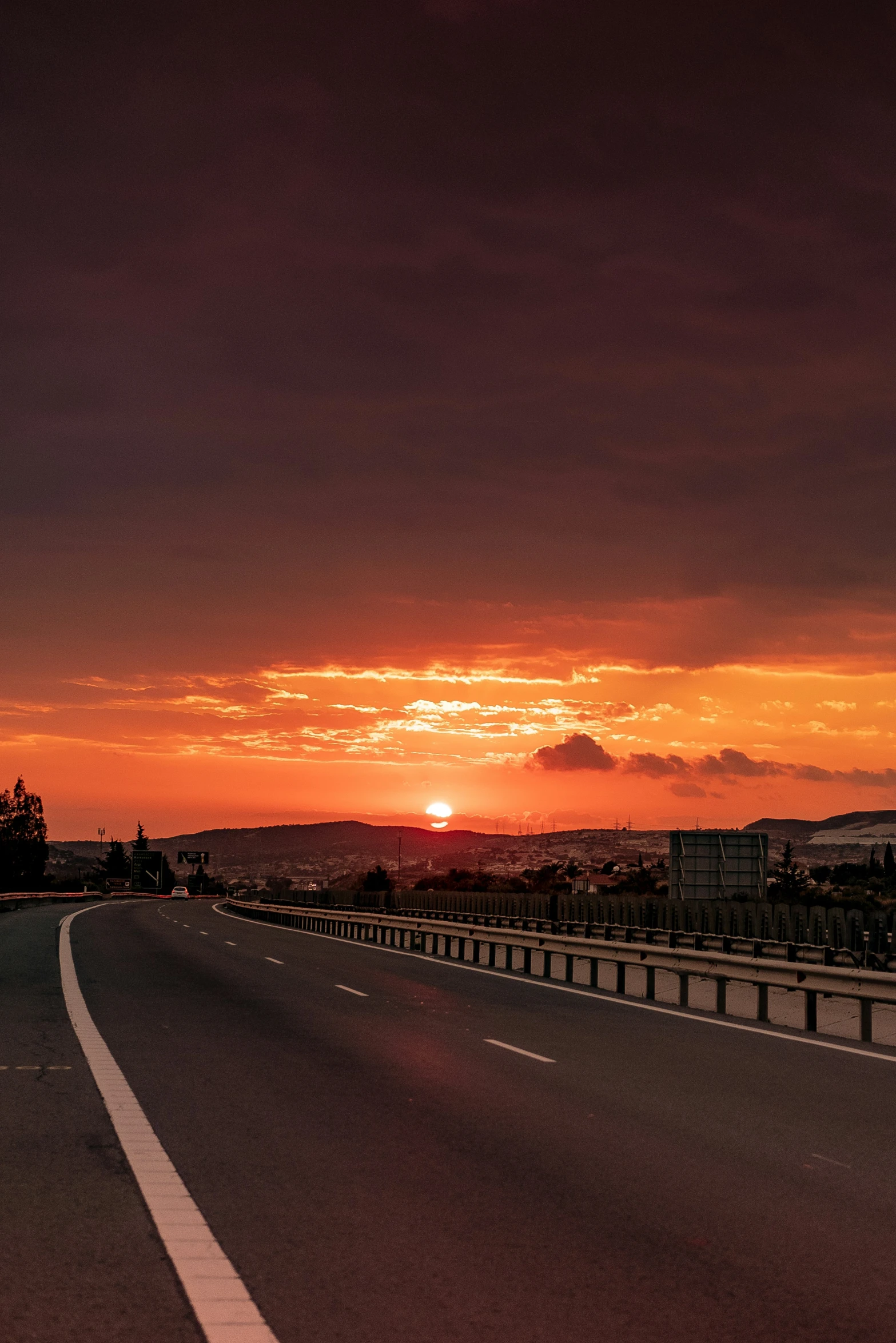 the sun is going down on a highway