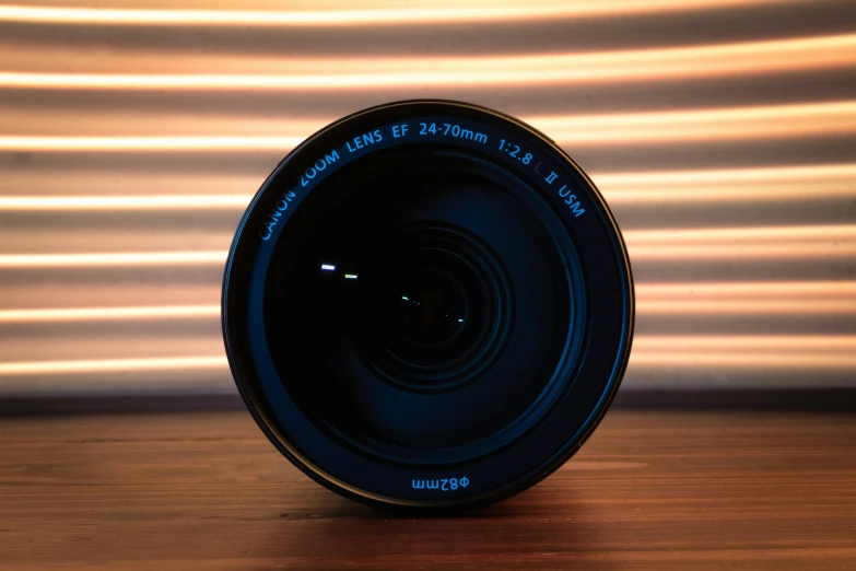 a camera lens sitting on a wooden table