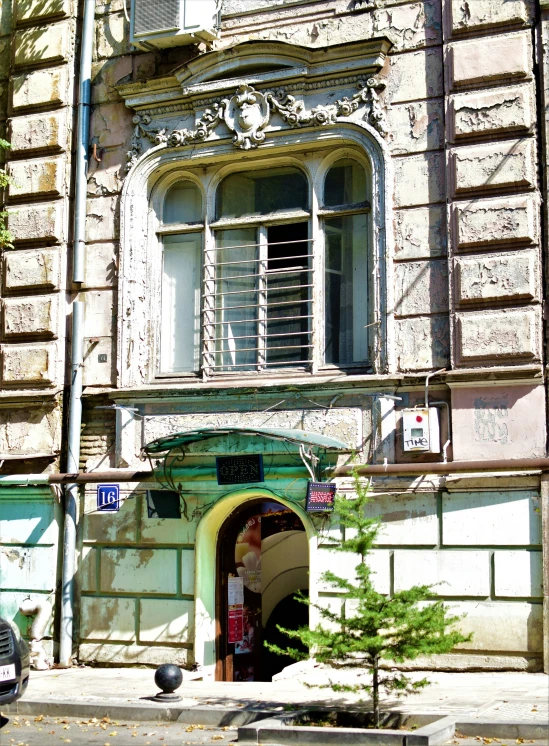 there is a man standing outside a doorway to a building