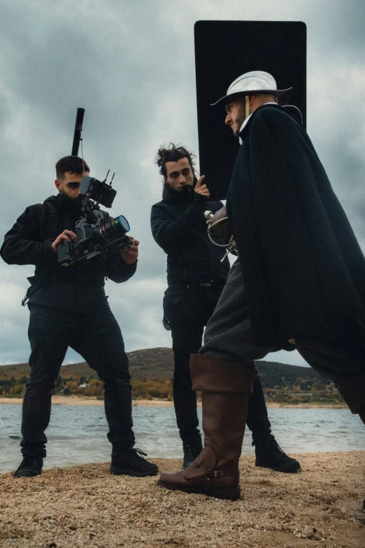 three men in costumes and carrying equipment on the ground