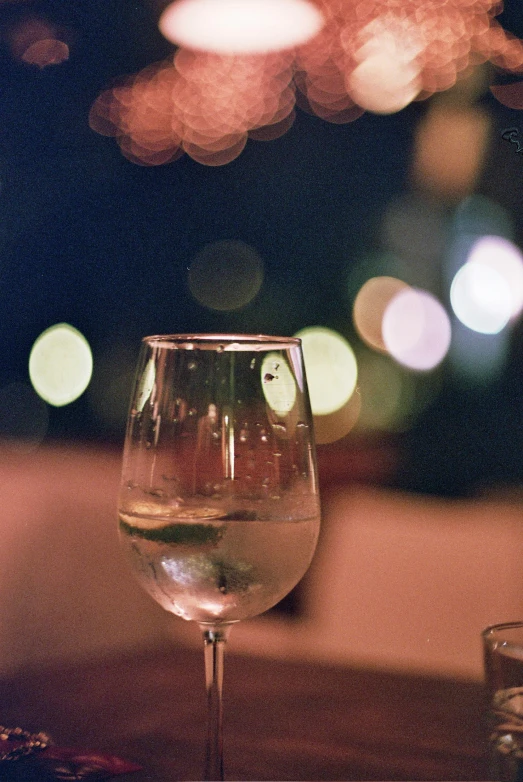 a glass of wine sitting next to another glass