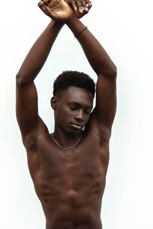 an african man holding his hand up in the air