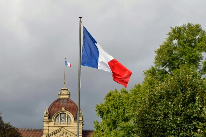 the flag of france blowing in the wind at half mast