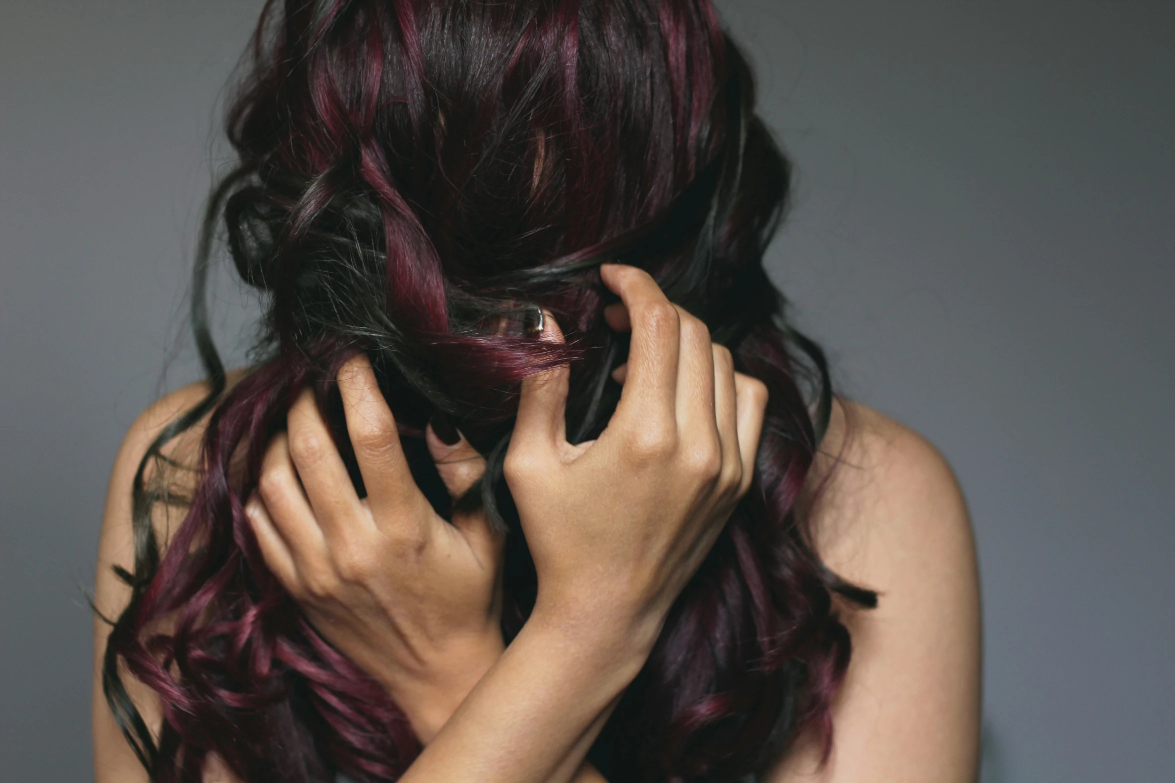 woman holding her hair up to the side