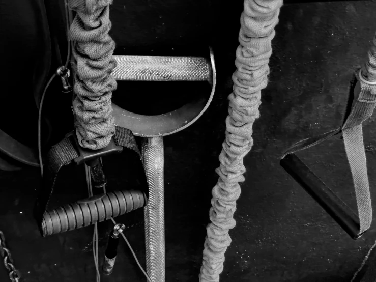 black and white image of a chair and ropes