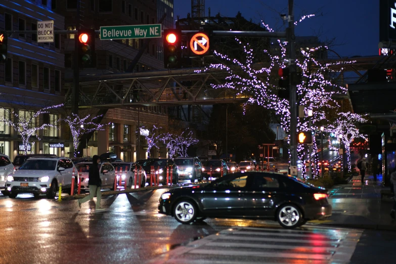 a city intersection with lights and christmas decorations
