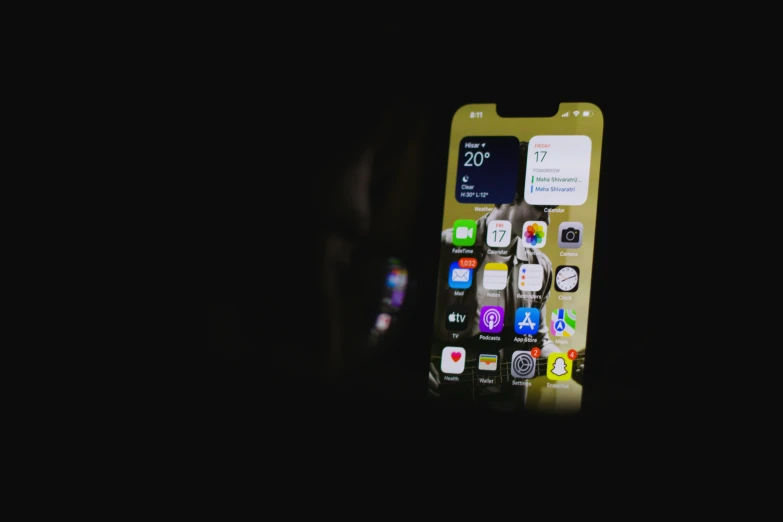 a close up view of an iphone in the dark