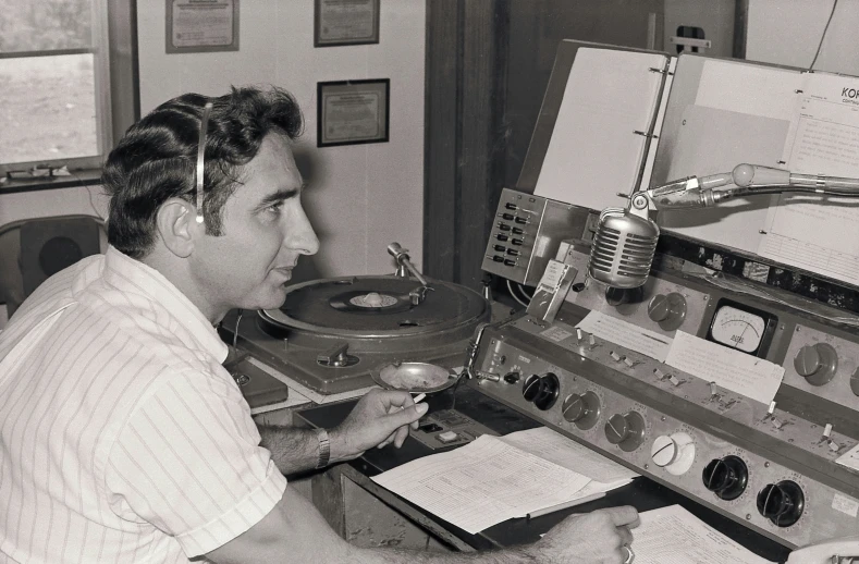 black and white po of a man operating a radio