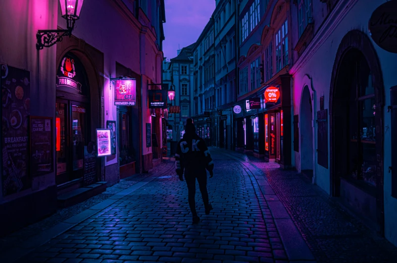 two people walking down a dark alley at night