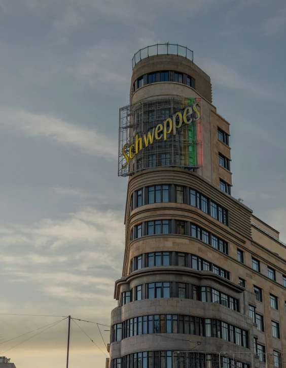 a very tall building with a colorful sign on it's side