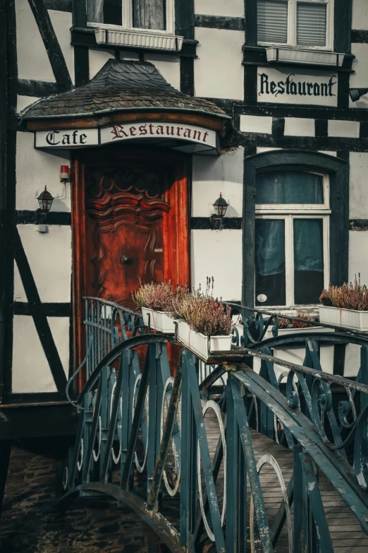 a very nice wooden bridge by an old building