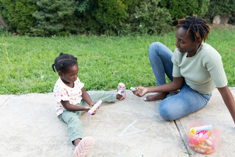 a woman and a little girl sitting next to each other