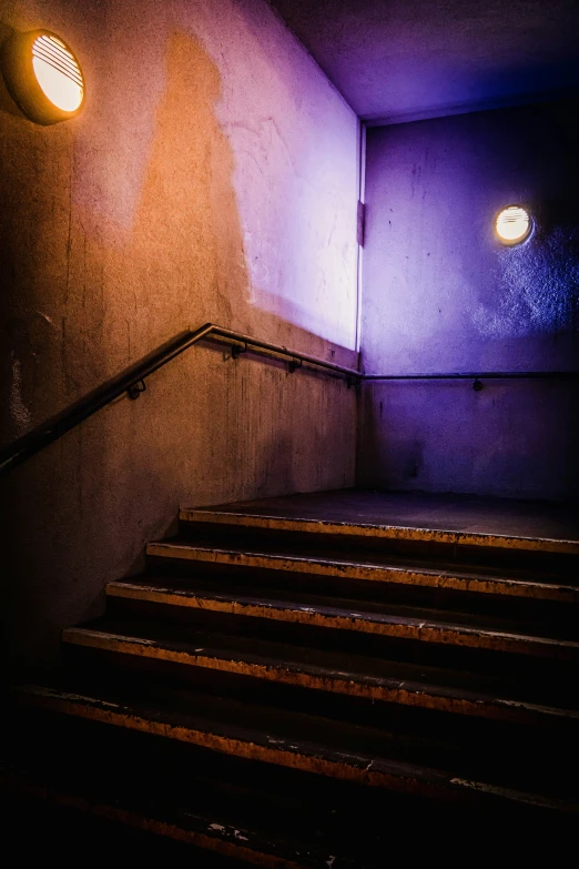 stairs in a dark room and light shining on them