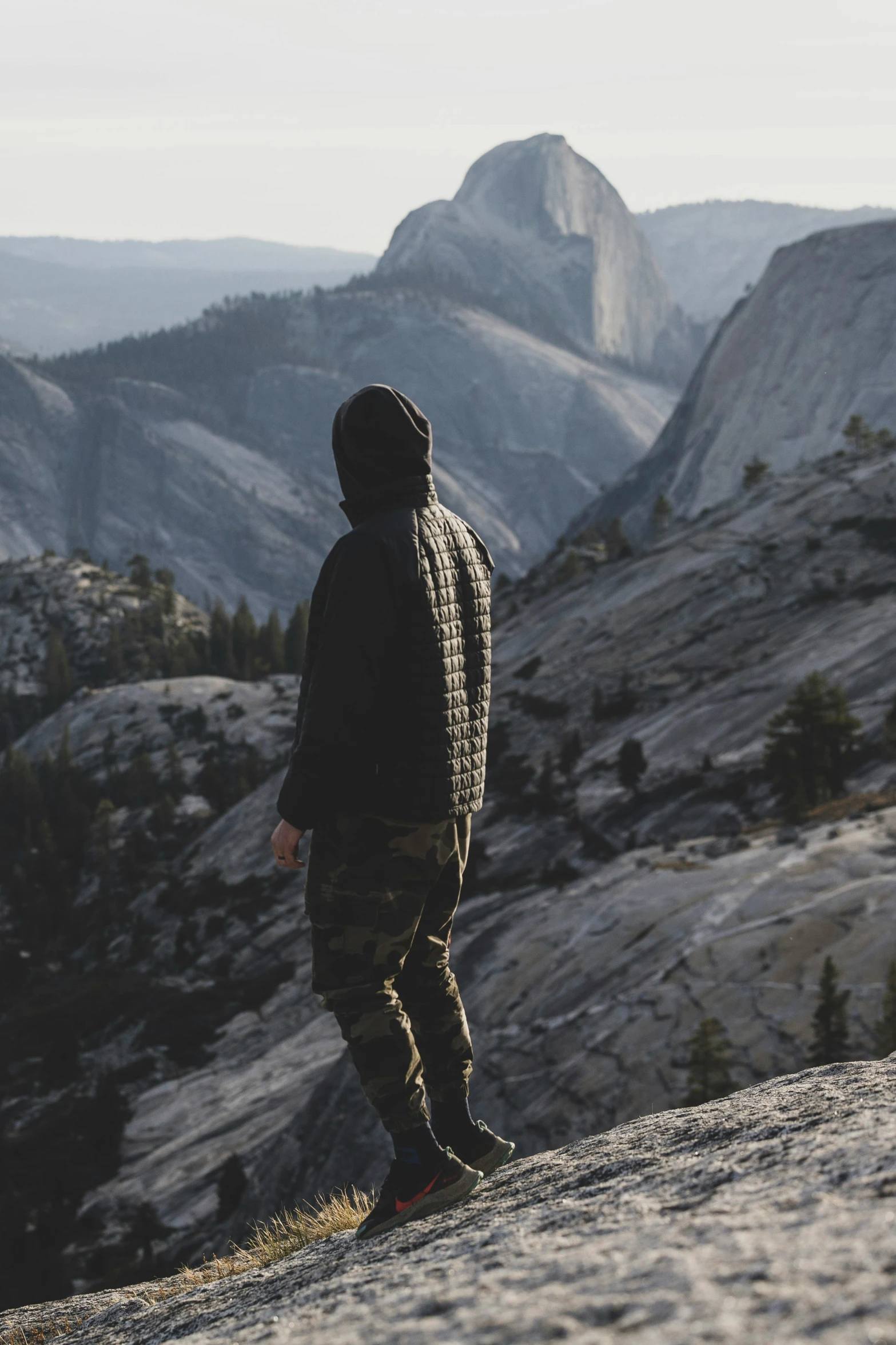 a person standing on top of a mountain looking at the mountains