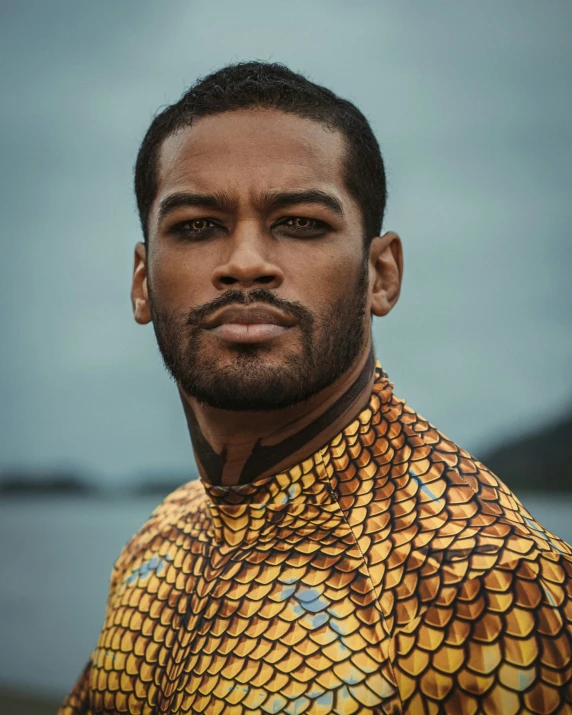 a man with a yellow and blue snake print shirt
