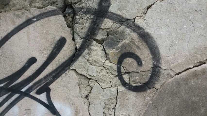 an artistic bike shadow on a rock wall
