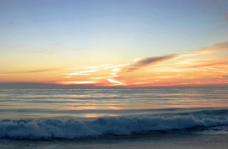 a body of water sitting next to a sandy beach