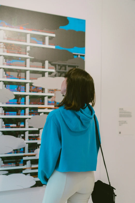 a person looking at a painting in a museum