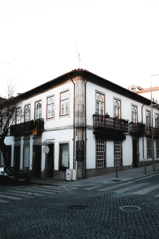 a building on the street has flowers on it