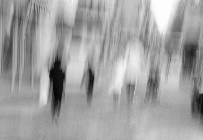 a blurry image of several people walking in the park